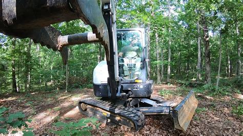 remove grass with a mini excavator|mini excavator land clearing.